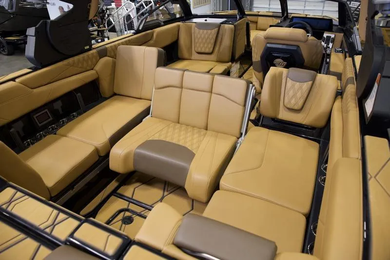 Slide: The Image of Luxurious interior of 2025 Malibu M242 boat with tan leather seating. - 20