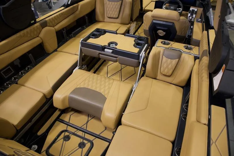 Slide: The Image of Luxurious interior of 2025 Malibu M242 boat with tan leather seating and modern amenities. - 22