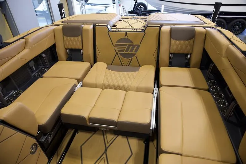 Slide: The Image of Luxurious interior of 2025 Malibu M242 boat with tan leather seating and modern design. - 23