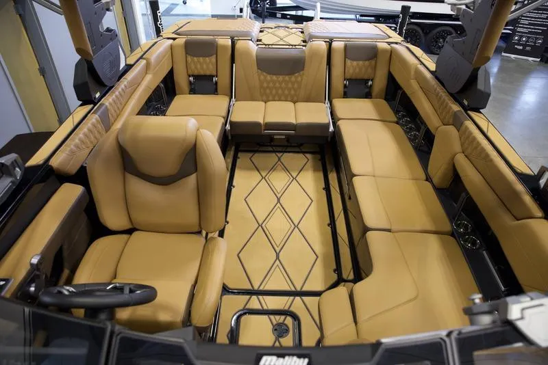 Slide: The Image of Luxurious interior of 2025 Malibu M242 boat with tan leather seating and modern design. - 24