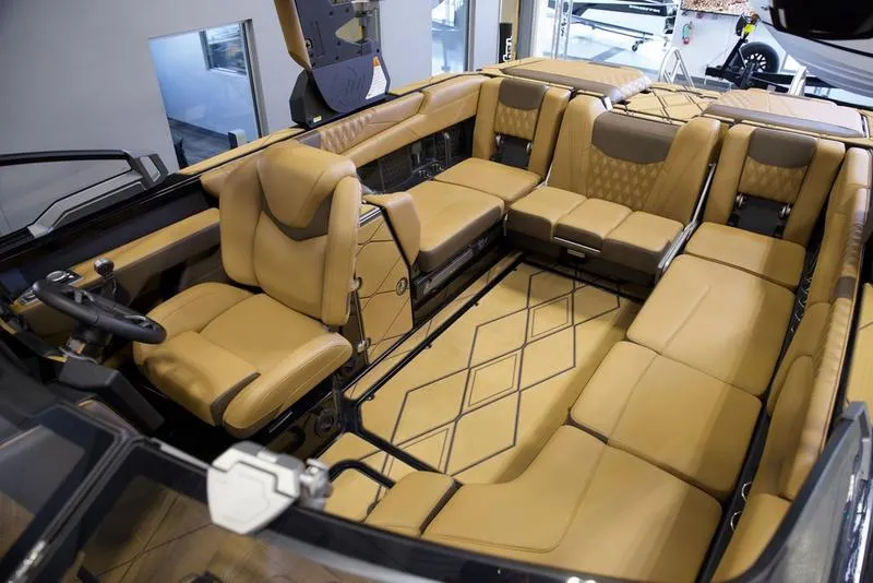 Slide: The Image of Luxurious interior of 2025 Malibu M242 boat with tan leather seating and modern design. - 26