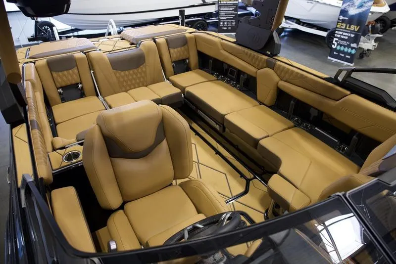 Slide: The Image of Luxurious interior of 2025 Malibu M242 boat with tan leather seating. - 27