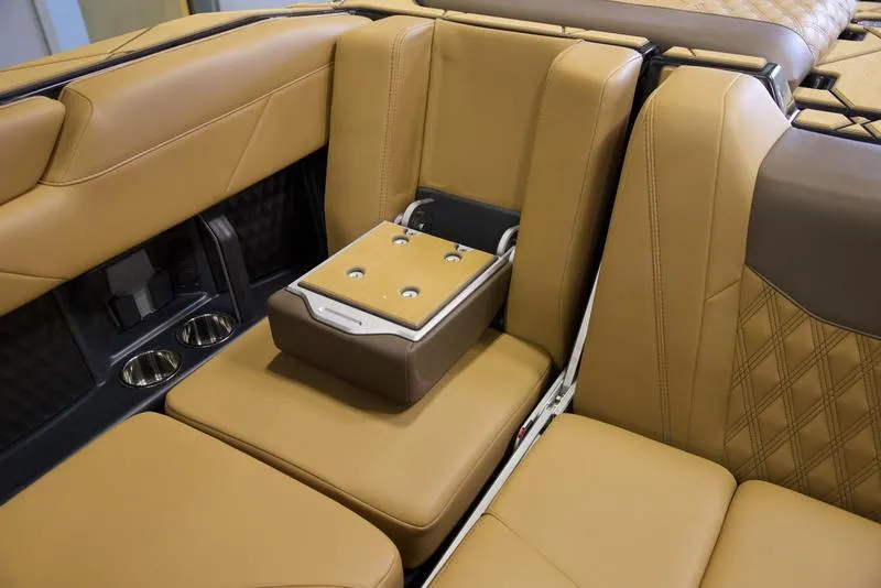 Slide: The Image of 2025 Malibu M242 interior with tan leather seats and built-in cup holders. - 28