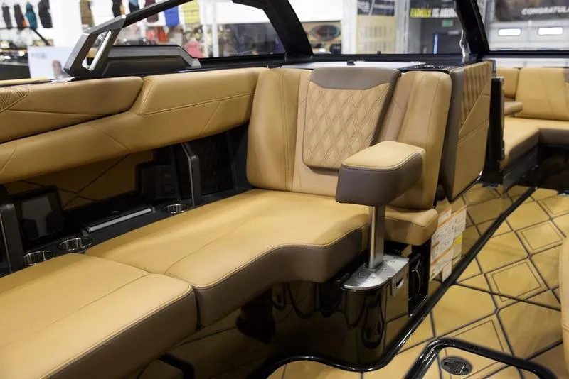 Slide: The Image of Luxurious interior of 2025 Malibu M242 boat with tan leather seating and modern design. - 29