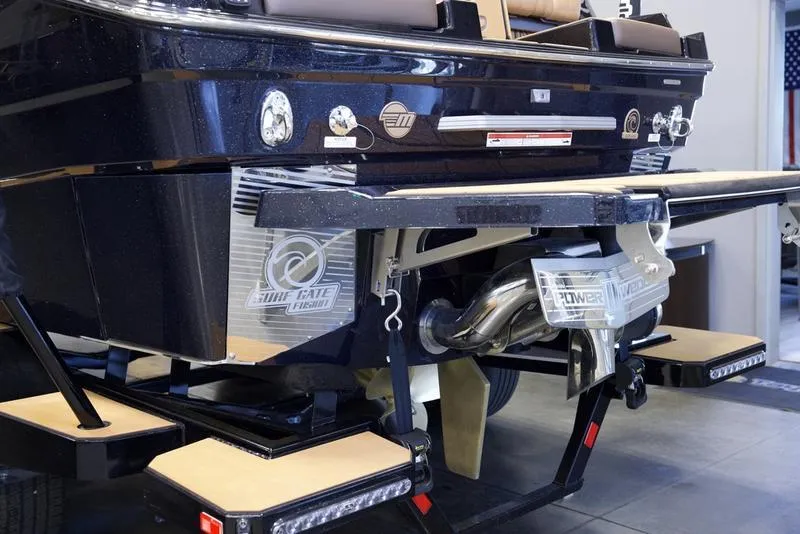 Slide: The Image of 2025 Malibu M242 boat rear view with advanced wakeboard features and sleek design. - 4