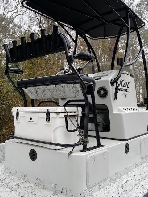 Slide: The Image of 2023 Dargel 250Kat HDX boat with rod holders and cooler on deck. - 12
