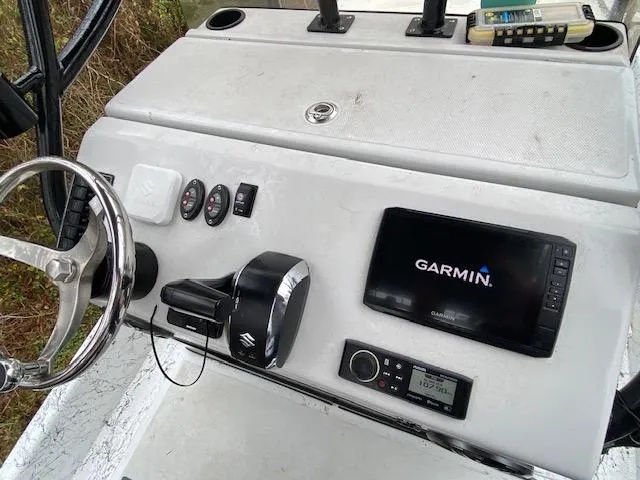 Slide: The Image of 2023 Dargel 250Kat HDX boat dashboard with Garmin navigation system and controls. - 16