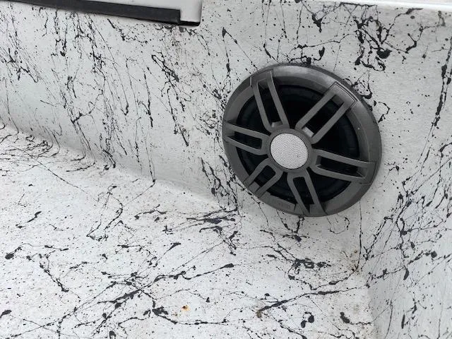 Slide: The Image of 2023 Dargel 250Kat HDX boat interior with a stylish speaker and marbled design. - 23
