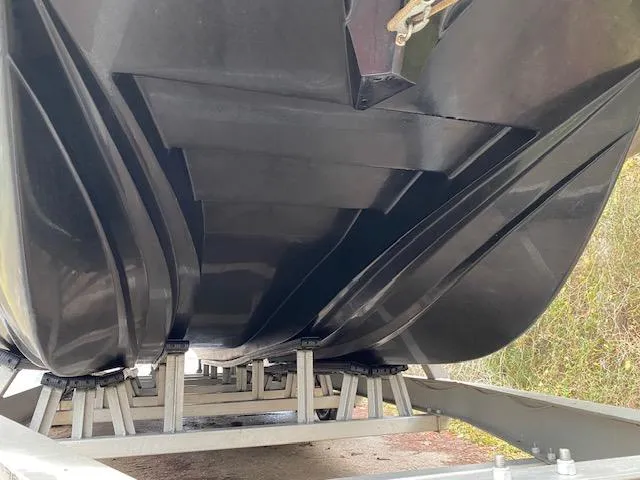Slide: The Image of Underside view of 2023 Dargel 250Kat HDX boat on a trailer. - 3