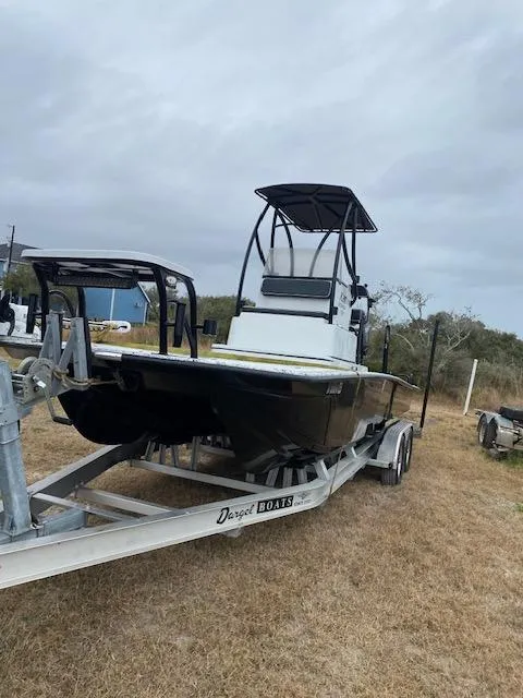 Slide: The Image of 2023 Dargel 250Kat HDX boat on trailer, parked on grassy area under cloudy sky. - 4