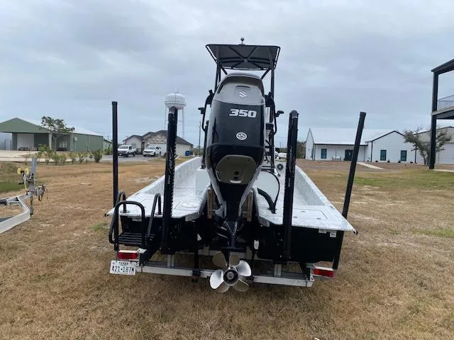 Slide: The Image of 2023 Dargel 250Kat HDX boat with Suzuki 350 engine, parked on grass. - 5