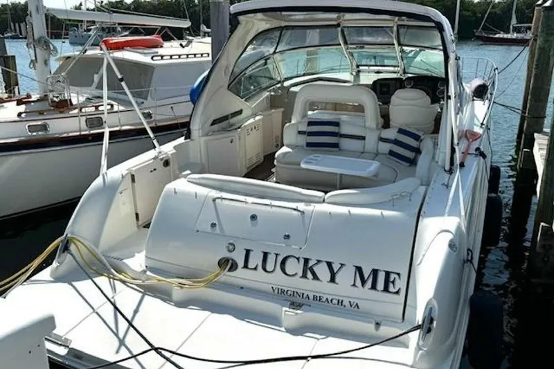 Slide: The Image of 2003 Sea Ray 420 Sundancer yacht interior with blue cover and ocean view. - 10