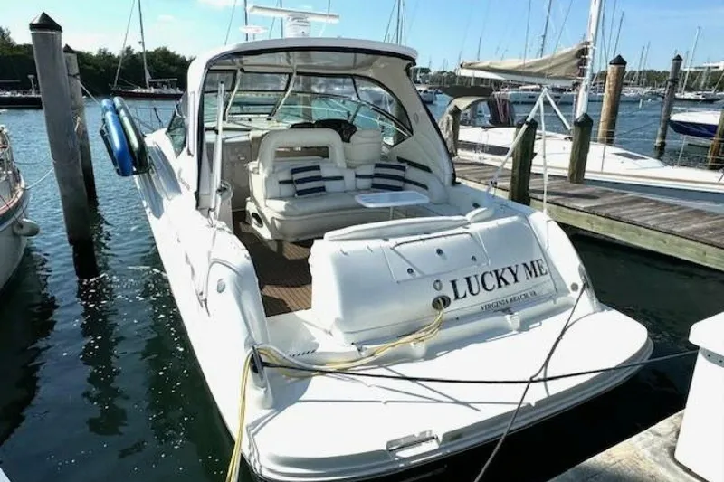Slide: The Image of 2003 Sea Ray 420 Sundancer yacht docked with paddleboards on deck. - 12