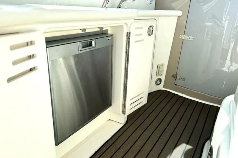 Slide: The Image of 2003 Sea Ray 420 Sundancer interior with white seating and helm station. - 17