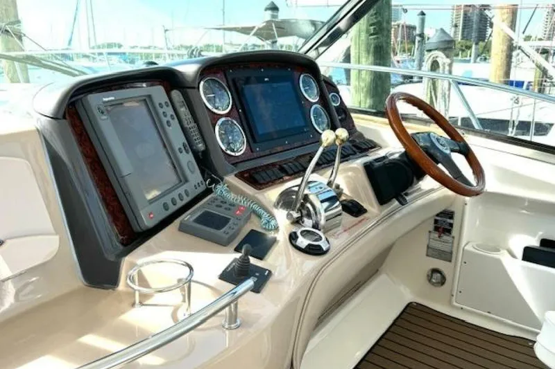 Slide: The Image of Helm of 2003 Sea Ray 420 Sundancer with navigation equipment and steering wheel. - 19
