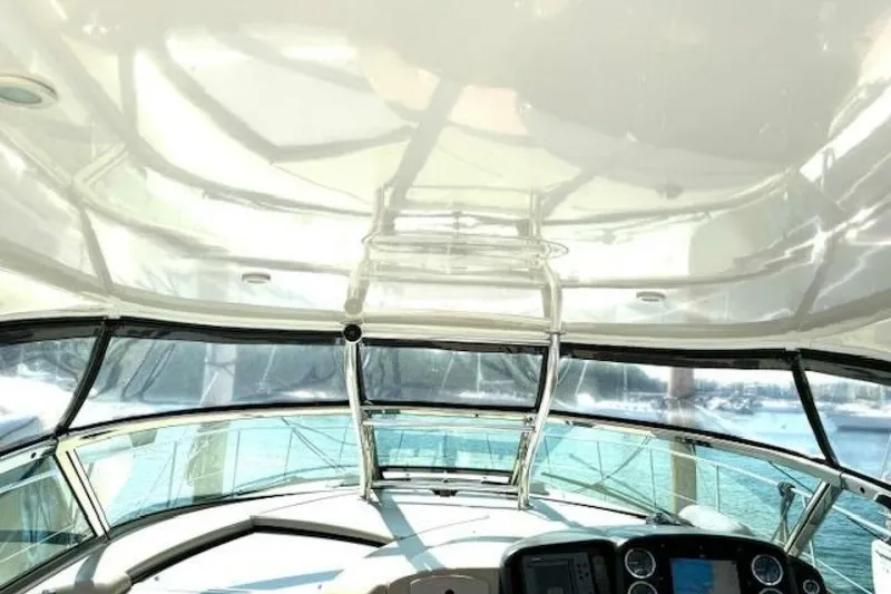 Slide: The Image of Cockpit of 2003 Sea Ray 420 Sundancer with navigation instruments and steering wheel. - 26