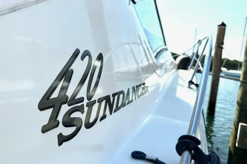 Slide: The Image of 2003 Sea Ray 420 Sundancer yacht docked at a marina, featuring a sleek design. - 27