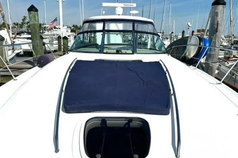 Slide: The Image of 2003 Sea Ray 420 Sundancer yacht docked in a marina with other boats. - 31