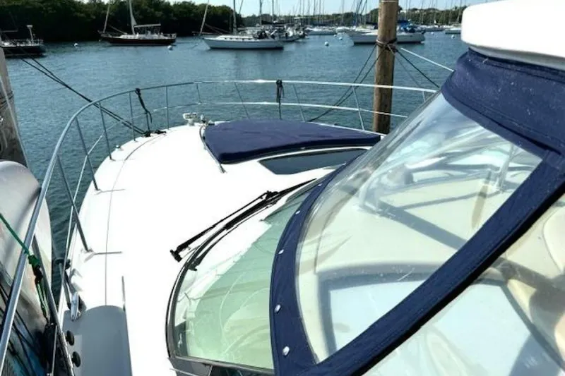 Slide: The Image of Luxurious interior of 2003 Sea Ray 420 Sundancer yacht with white seating and striped cushions. - 36