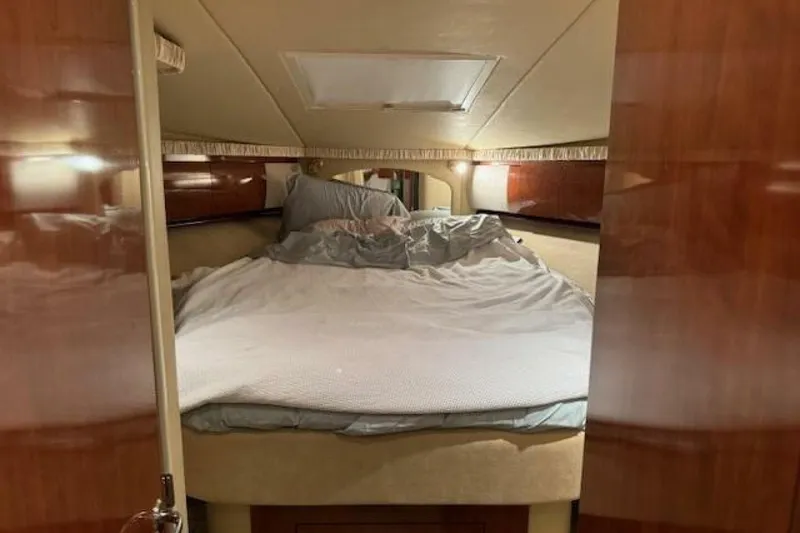 Slide: The Image of Interior cabin of 2003 Sea Ray 420 Sundancer with beige leather seating and storage. - 39