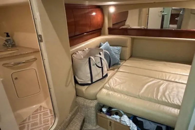 Slide: The Image of Luxurious interior of 2003 Sea Ray 420 Sundancer with plush seating and elegant wood table. - 40