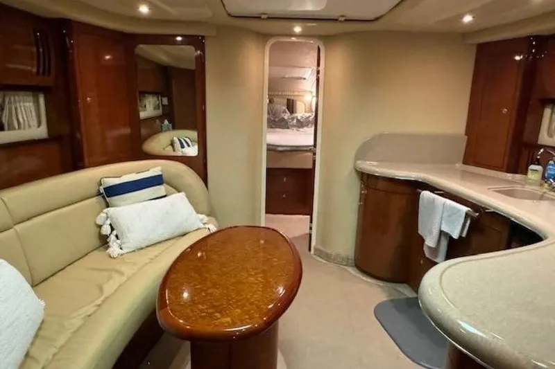 Slide: The Image of Interior of 2003 Sea Ray 420 Sundancer yacht with elegant wood finishes and cozy seating. - 42
