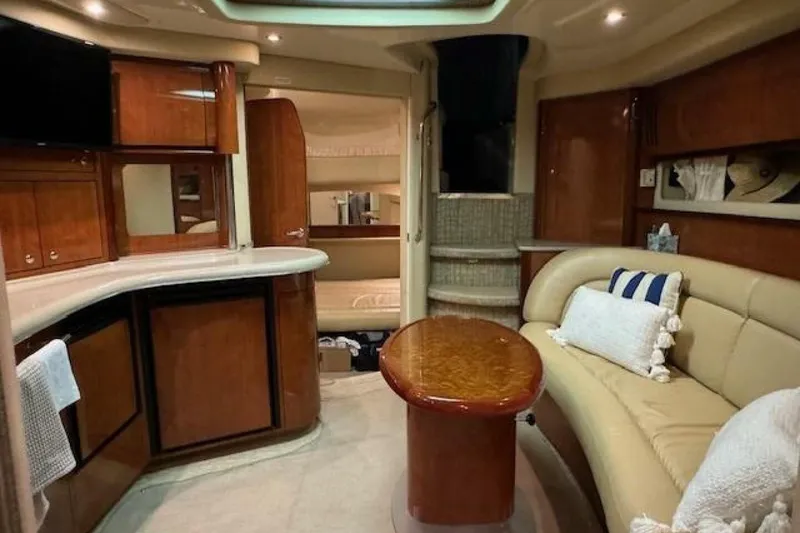 Slide: The Image of 2003 Sea Ray 420 Sundancer yacht at night, reflecting on calm water. - 43