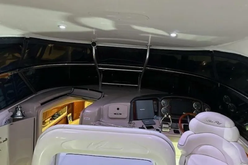 Slide: The Image of 2003 Sea Ray 420 Sundancer yacht docked in a marina with city skyline. - 46