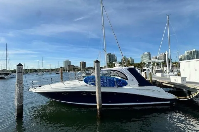 Slide: The Image of 2003 Sea Ray 420 Sundancer docked, named "Lucky Me," at a marina. - 48