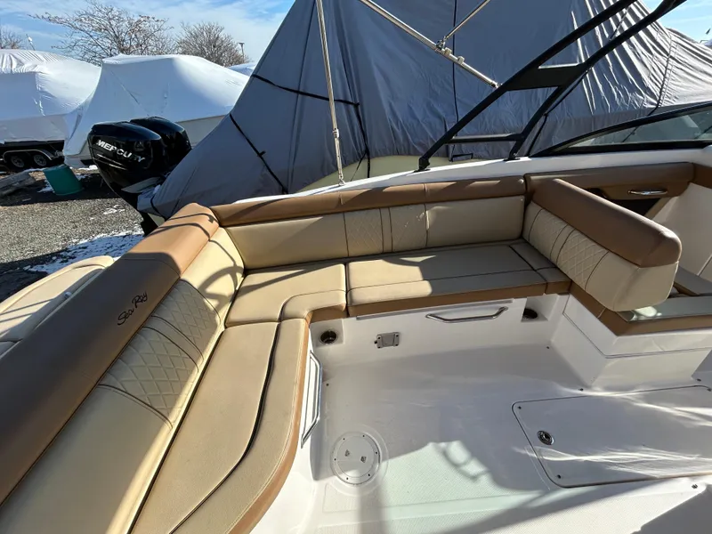 Slide: The Image of 2015 Sea Ray 270 Sundeck boat interior with tan seating and covered exterior. - 3