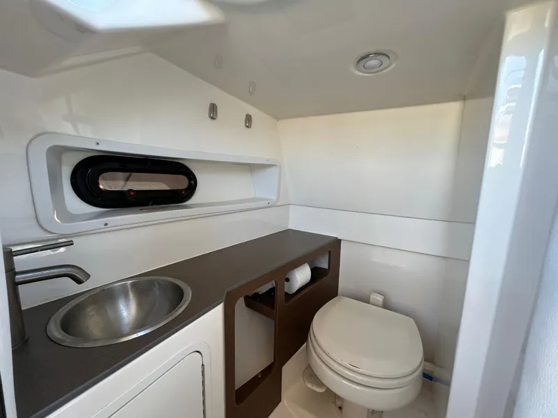 Slide: The Image of 2015 Sea Ray 270 Sundeck boat bathroom with sink and toilet. - 7