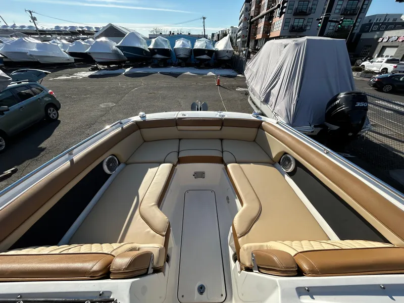 Slide: The Image of 2015 Sea Ray 270 Sundeck boat with spacious seating, docked in a marina. - 8