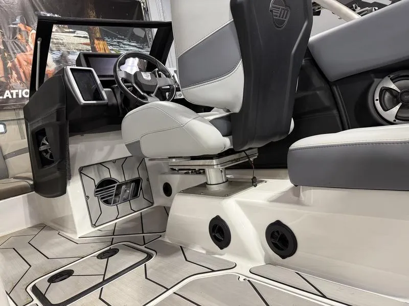 Slide: The Image of Interior of 2020 Malibu 24 MXZ boat with modern seating and dashboard design. - 11