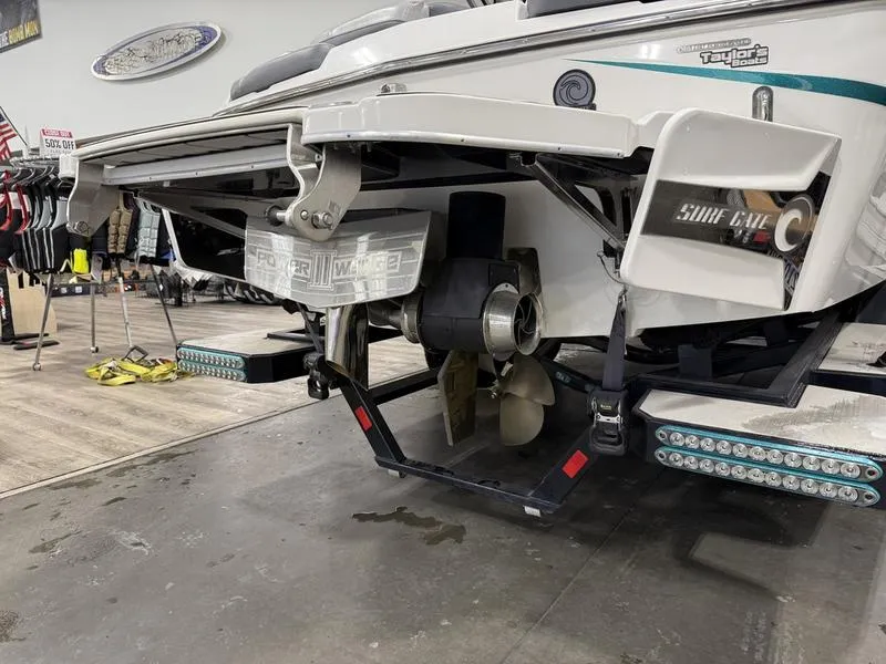 Slide: The Image of 2020 Malibu 24 MXZ boat rear view with propeller and surf gate system. - 4