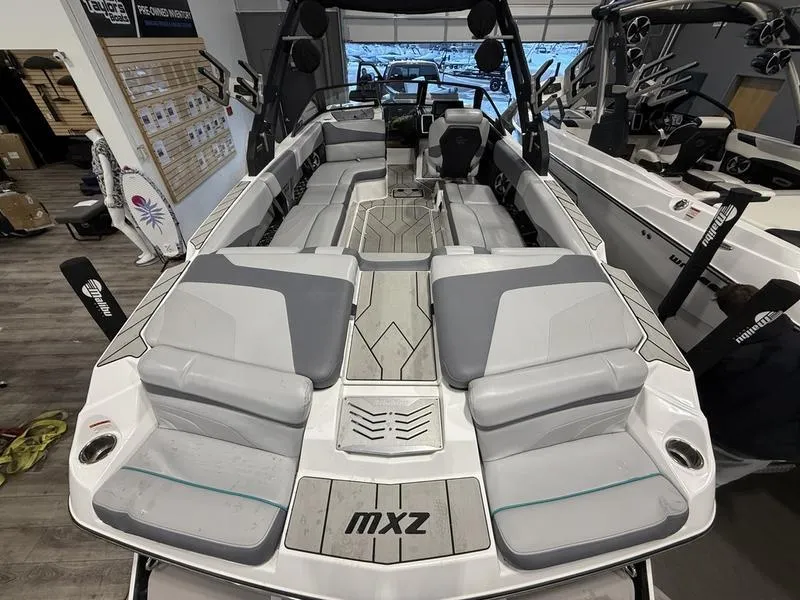 Slide: The Image of 2020 Malibu 24 MXZ boat interior with gray seating and modern design. - 5