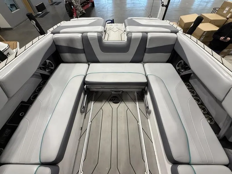 Slide: The Image of Interior of a 2020 Malibu 24 MXZ boat with gray seating and modern design. - 6