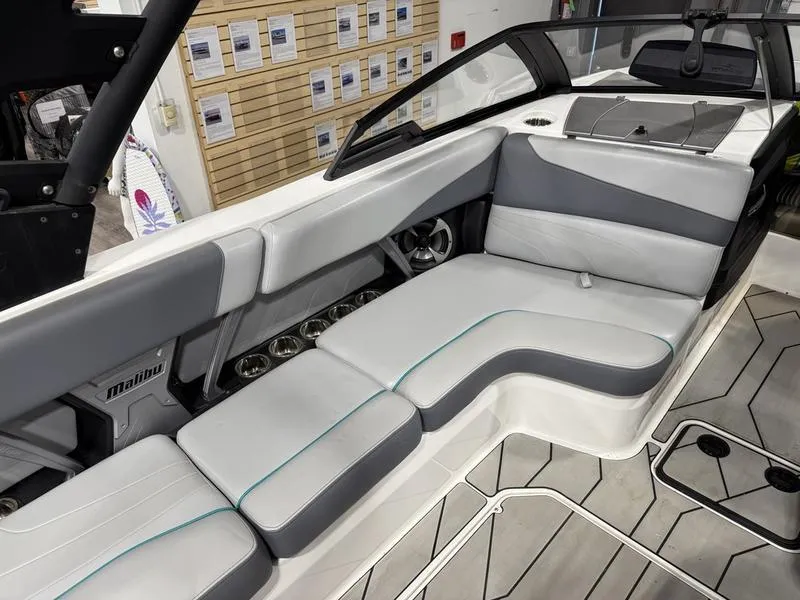 Slide: The Image of 2020 Malibu 24 MXZ boat interior with gray and white seating, modern design. - 7