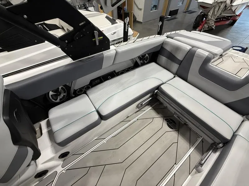 Slide: The Image of Interior of 2020 Malibu 24 MXZ boat with sleek gray seating and modern design. - 8
