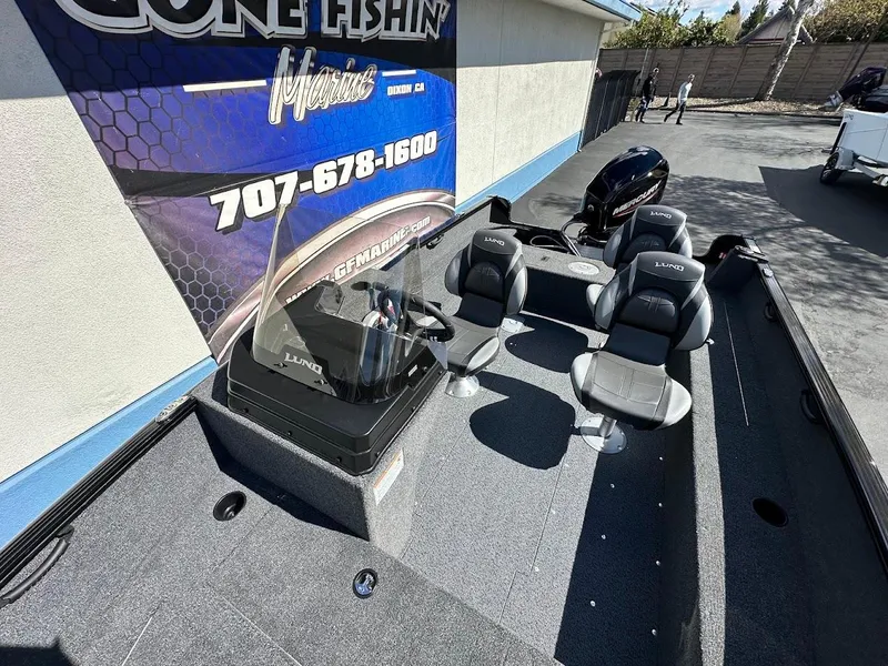 Slide: The Image of 2025 Lund 1650 Rebel XL SS boat interior with seating and controls. - 11