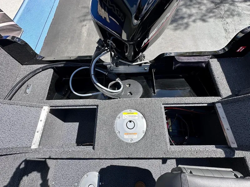 Slide: The Image of 2025 Lund 1650 Rebel XL SS boat interior with motor and storage compartments. - 13