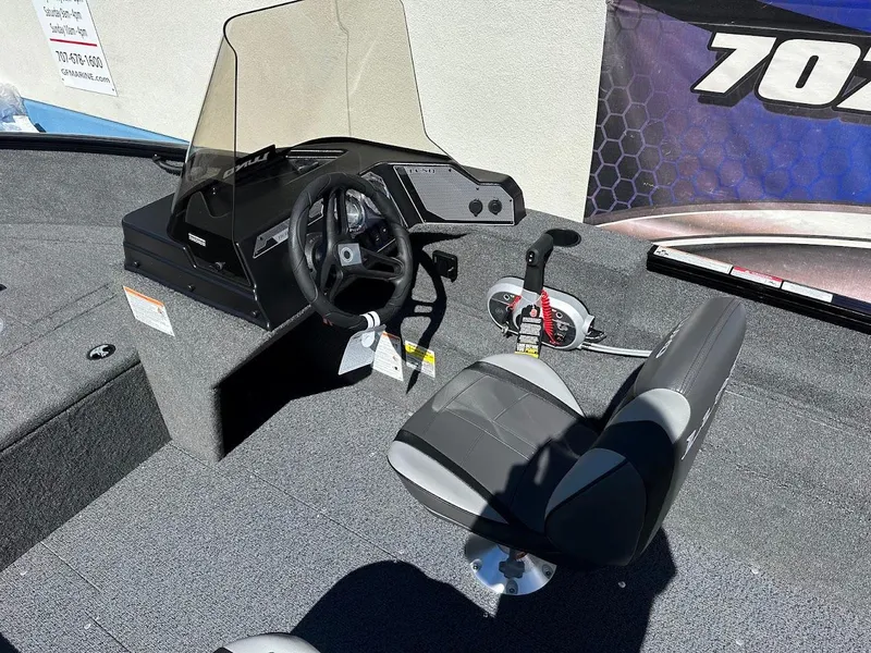 Slide: The Image of 2025 Lund 1650 Rebel XL SS boat interior with steering console and seating. - 17