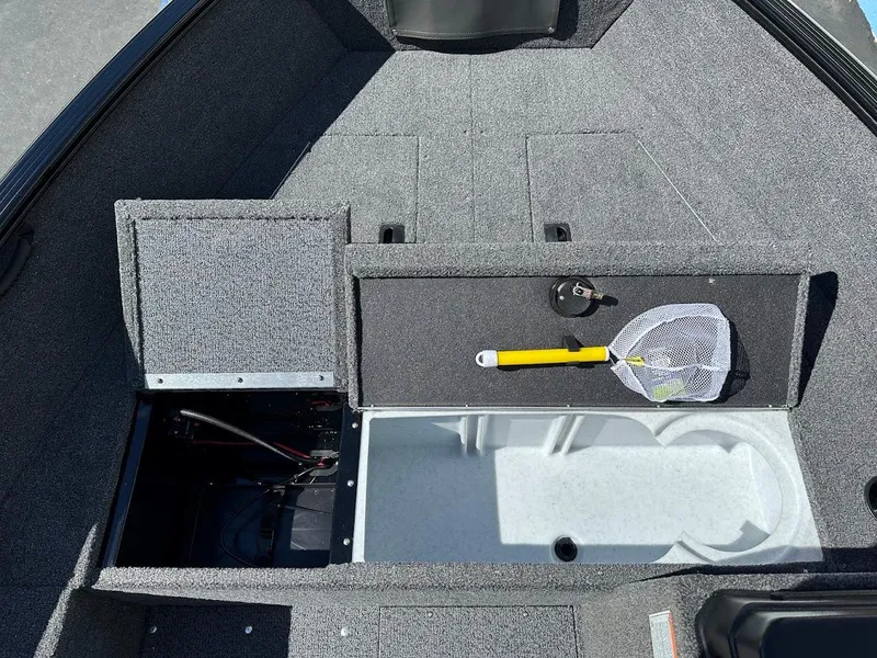 Slide: The Image of 2025 Lund 1650 Rebel XL SS boat interior with storage compartments and fishing net. - 21