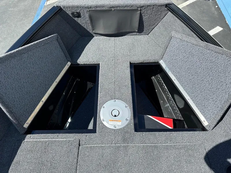 Slide: The Image of 2025 Lund 1650 Rebel XL SS boat interior with open storage compartments. - 22