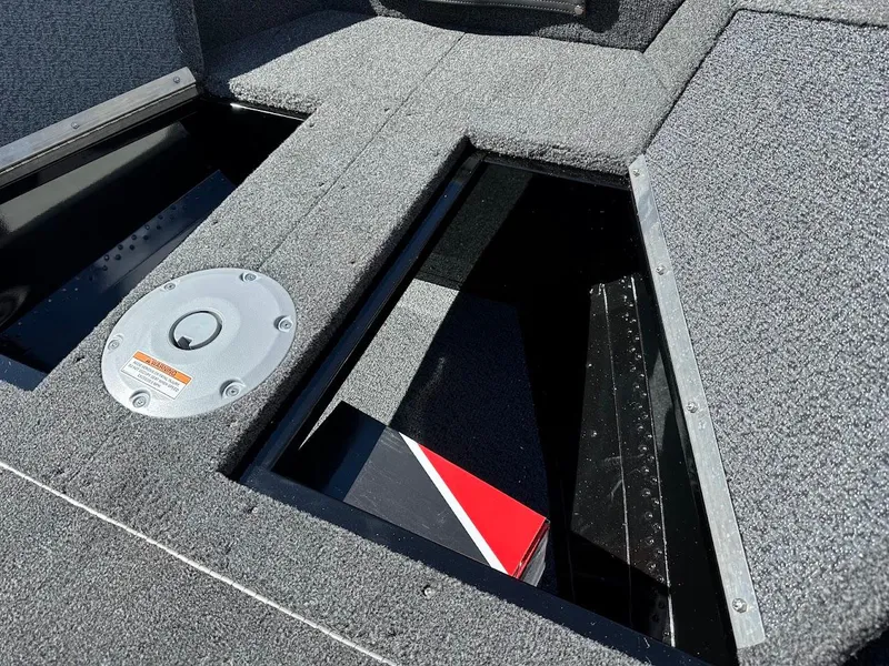 Slide: The Image of 2025 Lund 1650 Rebel XL SS boat interior with open storage compartments. - 24