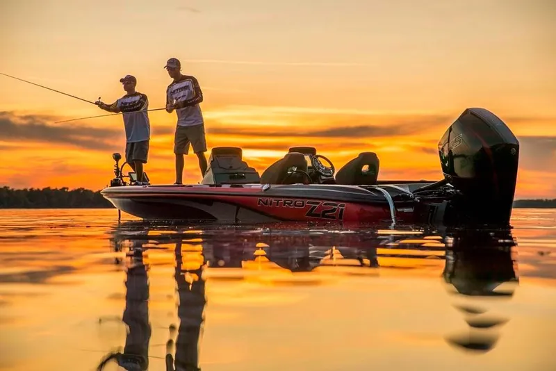 Slide: The Image of Two people fishing on a 2021 Nitro Z21 boat at sunset. - 7