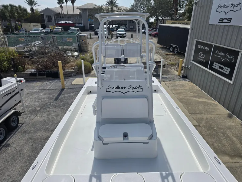 Slide: The Image of 2024 Shallow Sport X3 boat, white deck, outdoor display at dealership. - 10