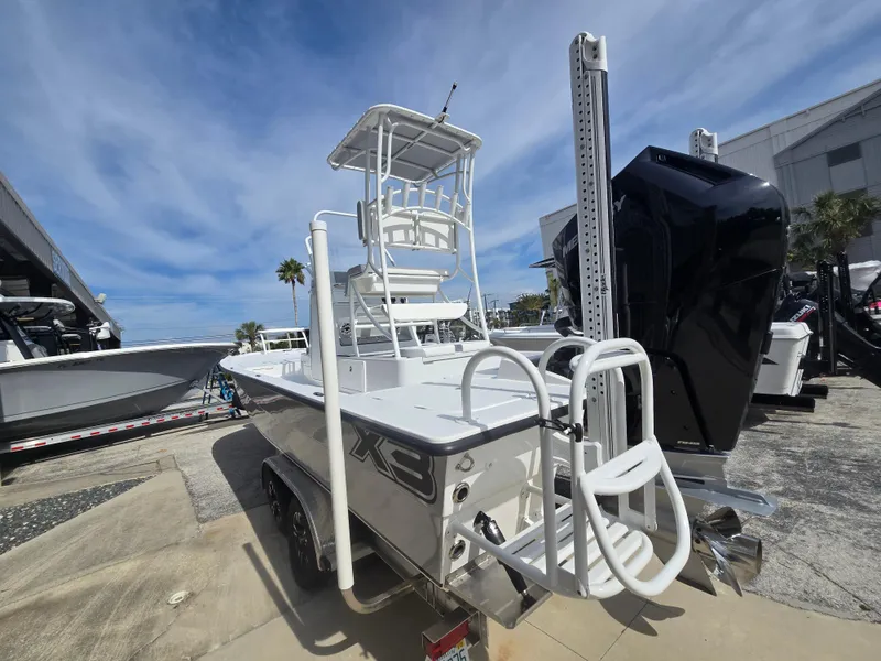 Slide: The Image of 2024 Shallow Sport X3 boat with elevated tower, displayed outdoors under a blue sky. - 23