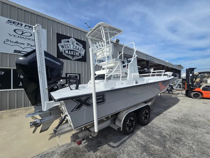 Slide: The Image of 2024 Shallow Sport X3 boat on trailer at West Coast Marine dealership. - 3