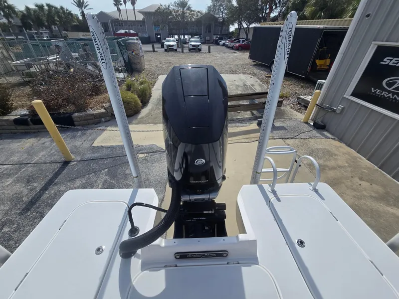 Slide: The Image of 2024 Shallow Sport X3 boat with outboard motor, docked at a marina. - 7