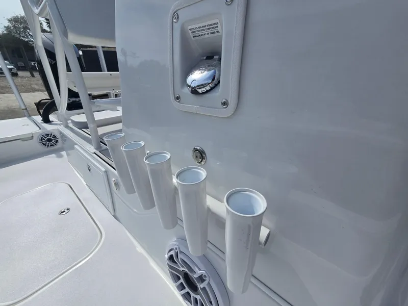 Slide: The Image of 2024 Shallow Sport X3 boat interior with rod holders and speaker. - 8